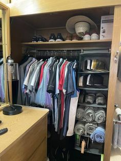 the closet is full of clothes and hats