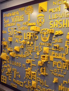 the wall is covered in yellow and black letters that spell out different languages on it