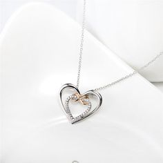 Discover the exquisite charm of our "Infinity Love Heart Sterling Silver Necklace" – a symbol of the timeless bond between two hearts. This necklace beautifully captures the essence of affection with its stunning design. The pendant features a larger silver heart-shaped outline, within which resides a smaller heart shape adorned with clear white cubic zirconias, adding a touch of brilliance and elegance. Overlapping this inner heart is a rose gold infinity symbol, representing the eternal nature Infinity Jewellery, Infinity Necklace With Names, Infinity Symbol Necklace, Infinity Necklace Gold, Infinity Cross, Infinity Necklace Silver, Necklace Infinity, I Carry Your Heart, Present For Her