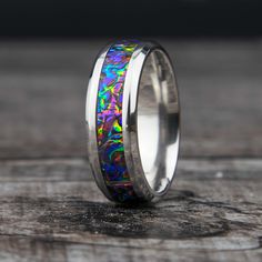 "Dichrolam Titanium Ceramic Ring. This band is created with the Fire Burl Dichrolam material. A rainbow of colors. This ring is like a party on your finger! What is Dichrolam? The Dichroic Optical Core within each lamination is unique in its ability to filter and reflect specific wavelengths of light. This results in a product that will produce dramatic color shifts as the viewing angle changes -- literally changing color before your very eyes. The same optical effects you see in natural opals, butterfly wings, and soap bubbles. // Ring Sizing And Returns // Please double check your ring size before ordering. Please also check if the sizing was done with a comfort fit or standard fit and that the ring listed matches standard or comfort fit. If you don't know your ring size please contact m Multicolor Polished Finish Rings For Gift, Multicolor Polished Rings Perfect As Gift, Multicolor Polished Rings As A Gift, Multicolor Polished Rings For Gifts, Multicolor Opal Jewelry For Anniversary, Round Multicolor Jewelry For Promise, Wedding Band Unique, Ceramic Ring, Titanium Ring