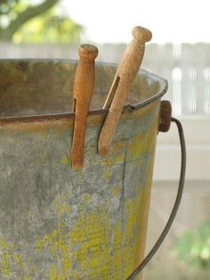 two wooden sticks sticking out of a bucket