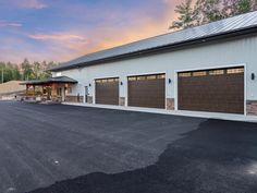 a large white building with two brown garage doors