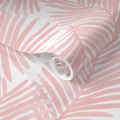 a pink and white wallpaper with palm leaf designs on it's side,