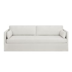 a white couch sitting on top of a white floor