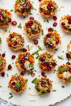 small appetizers are arranged on a white platter