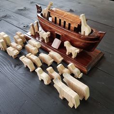 a wooden model of a boat and several pieces of wood are arranged on the floor