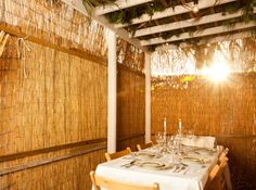 a table set for two with the words happy sukkat written on it in white