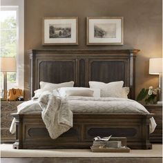 a bedroom with a bed, dresser and two framed pictures on the wall above it