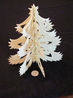 a white paper christmas tree sitting on top of a table