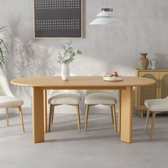 a dining table with white chairs around it