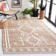 a living room with a chair, rug and potted plants in front of the window