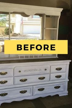 a white dresser with the words before painted on it in front of a large window