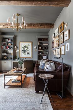 a living room filled with furniture and pictures on the wall