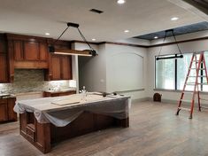 an empty kitchen is being remodeled with wood flooring