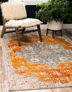 an orange and gray rug with a white chair