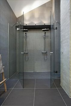 a walk in shower sitting inside of a bathroom