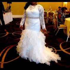 a woman in a wedding dress standing on a carpet