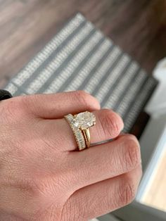 a man's hand with a ring on it and a diamond in the middle