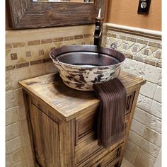 a bathroom sink sitting on top of a wooden cabinet