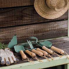 gardening utensils and garden implements sit on a bench