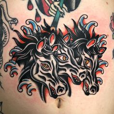 a man with some tattoos on his chest and two horses in the middle of it