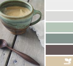 a cup of coffee on a wooden table with spoons and color swatches in the background