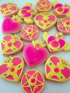 pink and yellow decorated cookies on a white surface