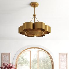 a living room filled with furniture and a large round window next to a table covered in flowers