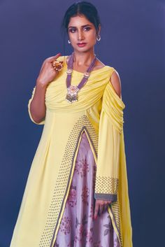 a woman in a yellow dress with jewelry on her neck