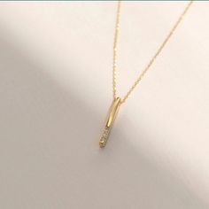 Introducing the Diamond Vertical Bar Necklace in 14k Solid Gold, this piece is designed for those who appreciate classic simplicity and seek a versatile layering accessory. It's the secret ingredient that complements any outfit, offering an elegant and timeless touch. This necklace is the essential personalized addition to your jewelry collection. Here are the key details: Handcrafted from 14k solid gold All materials are sourced from the United States Size Information: Material: 14k Solid Gold Diamond Type: Natural Diamond Quality: Carat Weight: 0.01 carats Color: F-G Clarity: VS2 Cut: Excellent Pendant Height: 15 mm / 0.59 inches Pendant Width: 1 mm / 0.03 inches Chain Style: Cable Chain Chain Length: 18 inches Each piece includes a certificate of authenticity, and the product undergoes Elegant Necklace With Rectangular Pendant And Cable Chain, Elegant Rectangular Pendant Necklace With Cable Chain, Classic Diamond Bar Necklace For Formal Occasions, Elegant Diamond Necklace With Rectangular Pendant For Formal Occasions, Classic Bar Necklace With Diamond Accents For Gifts, Elegant Diamond Bar Necklace For Anniversary, Elegant Rose Gold Bar Necklace For Gift, Elegant Rose Gold Bar Necklace Gift, Elegant Diamond Accented Bar Necklace For Anniversary