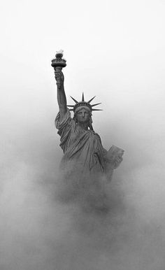 the statue of liberty is surrounded by fog