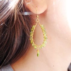 These beautiful fine hoop earrings have beautiful peridot gemstones and gold filled wire. The gemstones are genuine and are a beautiful green colour, and the drop shape gems dangle graciously. The genuine beads are wire wrapped around gold filled oval shape hoops. The hook is nickel free, slim and very light. Total length is 6 cm The roundels measure 3 mm, the briolette are 5 mm approximately You will receive the earrings in the picture. Thank you for visiting my shop and if you wish personalize Green Teardrop Hoop Earrings, Green Peridot Teardrop Earrings, Gold Teardrop Peridot Earrings, Teardrop Peridot Earrings For May Birthstone, Peridot Teardrop Earrings For May Birthstone, Earrings Wire, Precious Jewels, Hoops Earrings, Le Crochet