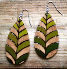 wooden earrings with green and brown leaves on them