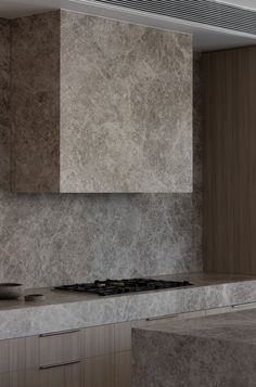 a stove top oven sitting inside of a kitchen next to a wall mounted range hood