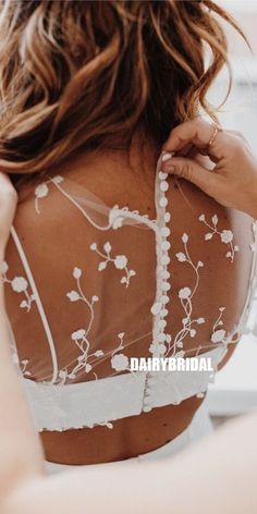 the back of a woman's bra with white flowers on it