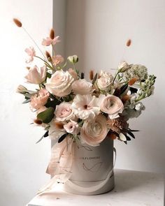 a bouquet of flowers in a bucket on a table