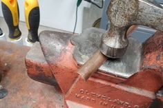 an old hammer and some tools on a work bench