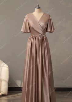 This V-Neck Long Short Sleeve Silk Satin Bridesmaid Dress is crafted from the finest silk satin for an exquisite look. The bell sleeve, pleated bodice, and skirt all contribute to a sophisticated silhouette, while the custom colors ensure you find the perfect shade to complement your special day. A back zipper finishes this luxurious bridesmaid dress. Fabric: Silk Stain Silhouette: A-line Length: Floor-Length Straps & Sleeves: Sleeves Back Style: Back Zip Fully Lined: Yes Built-In Bra: Yes Bonin Satin Gown Bridesmaid With Sleeves, Silk Long Dress Satin, Stain Dress, Bridesmaid Dresses Sleeves Short, Bridesmaid Dresses Silk Satin, Bridesmaid Dresses Satin Long, Bridesmaid Dresses Silk Satin With Sleeves, Bridesmaid Silk Dresses, Satin Outfits For Women