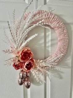 a pink wreath hanging on the front door