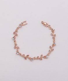 "This vine-like designed bracelet boasts brilliant rhinestones in brilliant rose gold metal. Bracelet measures 7\". Perfect for the wedding, bridesmaids or any special occasion! Choose from silver or rose gold finish. All jewelry features high quality electroplating that does not fade or chip and is nickel free (hypoallergenic). Orders are shipped via USPS with tracking and confirmation. Item arrives in a complimentary gift box. ------------------------------------------------------- Questions? Adjustable Rose Gold Tennis Bracelet For Wedding, Rose Gold Bracelet For Women, Rose Gold Crystal Bracelet For Gift, Rose Gold Crystal Bracelet Gift, Adjustable Rose Gold Diamond Bracelet For Wedding, Rose Gold Crystal Bracelet With Sparkling Stones For Party, Adjustable Rose Gold Crystal Bracelet For Formal Occasions, Party Rose Gold Crystal Bracelet With Sparkling Stones, Rose Gold Bracelets With Rhinestones