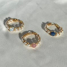 (items are shipped between 1-2 days) *Now available in silver!  A gold braided wire wrapped rings made with pearls and a round gemstone. Available in sodalite, opalite, and pink cat's eye! 💗I love pairing these dainty gemstone rings together but they also look cute on their own. They also make great gifts for loved ones.  All orders come in a white mesh bag making them great to gift in.  💗I recommend avoiding water and keeping it stored away when not being worn to maintain its quality. More Cr Pear Rings, Pearl Ring Gold, Gold Wire Ring, Diy Wire Jewelry Rings, Gold Wrap Ring, Wire Jewelry Rings, Diy Beaded Rings, Crystal Bead Jewelry, Wrapped Rings