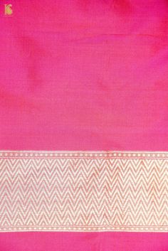 a pink and white sari with gold border