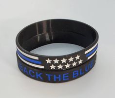 "We are so proud to be carrying these in our shop. Back The Blue Many use These great wristbands as a give away or a gift. Show your support for those who protect us everyday. Great for Easter Baskets and Party Favors. Design Description Black w/ blue lettering silicone bracelet featuring \"Back the Blue\" with Thin Blue Line Embossed Design Dimensions: 7.95\"x0.47\"x0.08\" inches (202x12x2)mm Each order contains 100 pieces Great as an Easter basket stuffer, party favor, stocking stuffer, secret Back The Blue Bracelets, Police Appreciation Gifts, Police Appreciation, Back The Blue, Everyday Backpack, Easter Basket Stuffer, Embossed Design, Blue Party, Silicone Bracelets