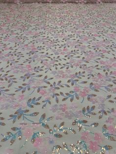 the floor is covered with pink flowers and blue sequins on white grounding