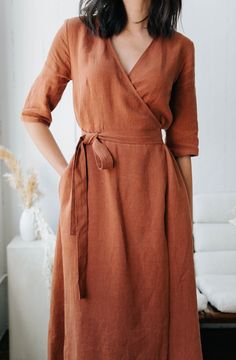 "This carefully tailored lightweight wrap dress has a cocktail length, fitted elbow length sleeves, a cinched waist, and an A-line circle skirt. It also has french darts, a built in wrap belt and invisible pockets. We used the highest quality linen sourced in Canada which is breathable, soft and pre washed with an antique finish. Like all of our pieces, this dress is handmade by us to order in our studio in British Columbia. Please provide us with your measurements so we can ensure the perfect f Womens Robes Long, Jewel Tone Dress, Linen Wrap Dress, Cowgirl Chic, Loungewear Luxury, Womens Robes, Wrap Dresses, Jacquard Knit, Loungewear Set