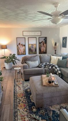 a living room filled with furniture and lots of pillows on top of a wooden floor