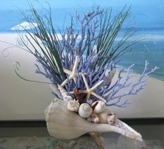 a vase filled with sea shells and starfish