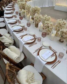 a long table set with place settings and napkins