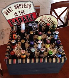 a wooden crate filled with bottles of beer on top of a table next to a sign that says what happens in the garage