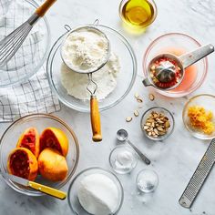 the ingredients to make peach cobbler are displayed on a marble counter top, including oranges and almonds